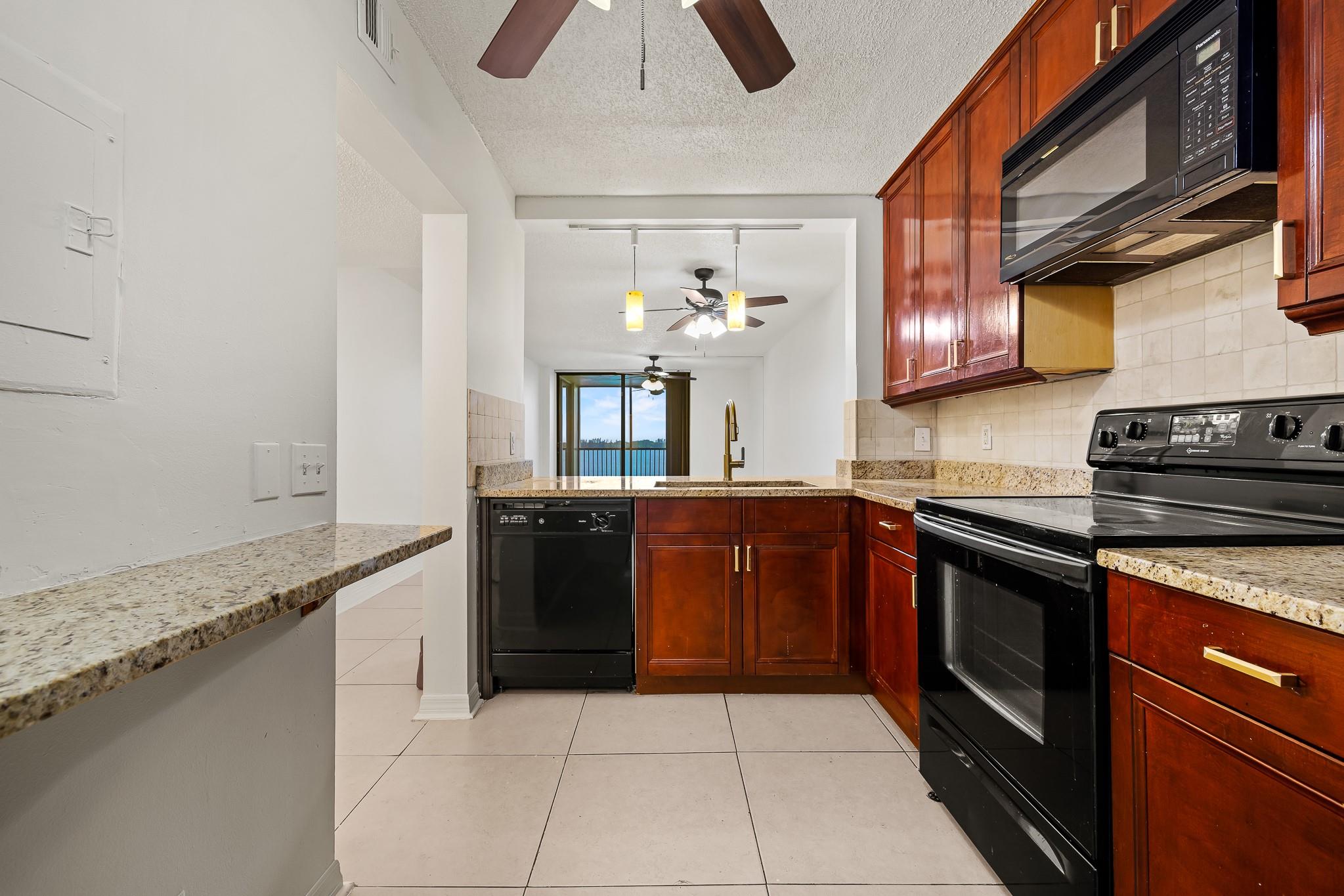 Wake up to stunning lakefront views from this top-floor condo in the gated Lake Emerald community! Enjoy spacious bedrooms, a renovated kitchen with granite countertops, large cabinets, and breathtaking sunset view from the large screened balcony. Water, cable & internet included! Resort-style amenities: 3 pools, 3 hot tubs, sauna, gym, tennis, basketball, BBQs w/ tiki huts, café, and a lakefront trail. Bring your kayak or paddleboard—navigable lake + watercraft storage under clubhouse. Easy access to I-95 & Turnpike, just 15 mins to beaches & downtown. Your serene escape awaits!