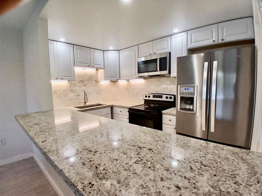 RENOVATED Condo! This Beautiful Condo is Completely Renovated with Premium Materials. BRAND NEW Kitchen Cabinets, GRANITE Countertops, Stainless Appliances. Bar Countertop Pass- Through to Living Area. Large Master Bedroom and Walk In Closet with Built-In Cabinets! All new Premium Flooring, New Washer, Dryer, Renovated Bathrooms, Freshly Painted. There is also a Nice Screened In Patio. Beautiful Lobby and Amenities.