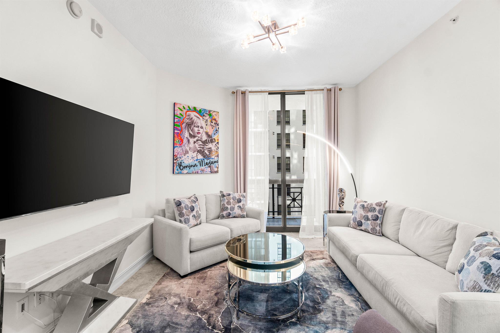Welcome to luxury living in the heart of downtown West Palm Beach, directly across from the soon-to-be-completed One Flagler office tower. This light-filled all new fully-furnished 2-bedroom, 2-bathroom condo boasts a wraparound balcony with water feature & garden views. Featuring tile and bamboo hardwood flooring throughout, condo has just been freshly painted, updated with all new lighting fixtures and refinished hardwood in the bedrooms. The master suite offers a spacious retreat with a king-size bed, large walk-in closet and a bathroom complete with a luxurious soaking tub. The second bedroom, perfect for guests or used as a flex room/office, includes its own private balcony entrance. Queen-sized sofa bed and desk offer the perfect flex space. The residence comes with premium garage..