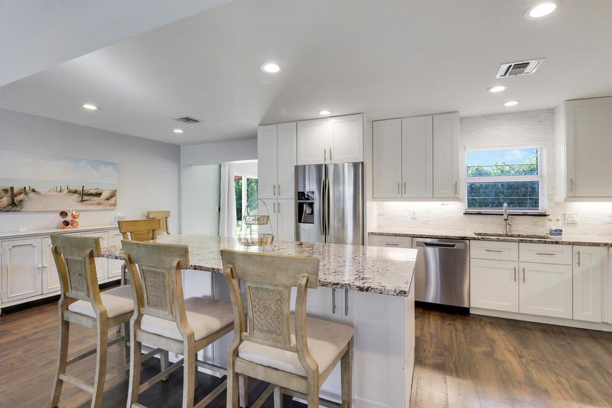 Welcome to this beautifully completely remodeled residence in the highly desirable Village of NPB. This 4 bed 2 bath home offers spacious living with top of the line finishes. Features include hardwood floors, updated kitchen with a large island, a vaulted living room ceiling and a generous dining area. Ideal for families and those enjoying the seasonal South FL lifestyle, this home is designed for effortless living and entertaining. Step into a serene tropical backyard, beautiful framed by colusa hedges offering privacy and a lush setting. Features also include  a covered lanai with a fire pit area and room for a boat or plenty of water toys. Enjoy easy access to Anchorage Park, NPB CC and outstanding dining. No detail was overlooked in this home.