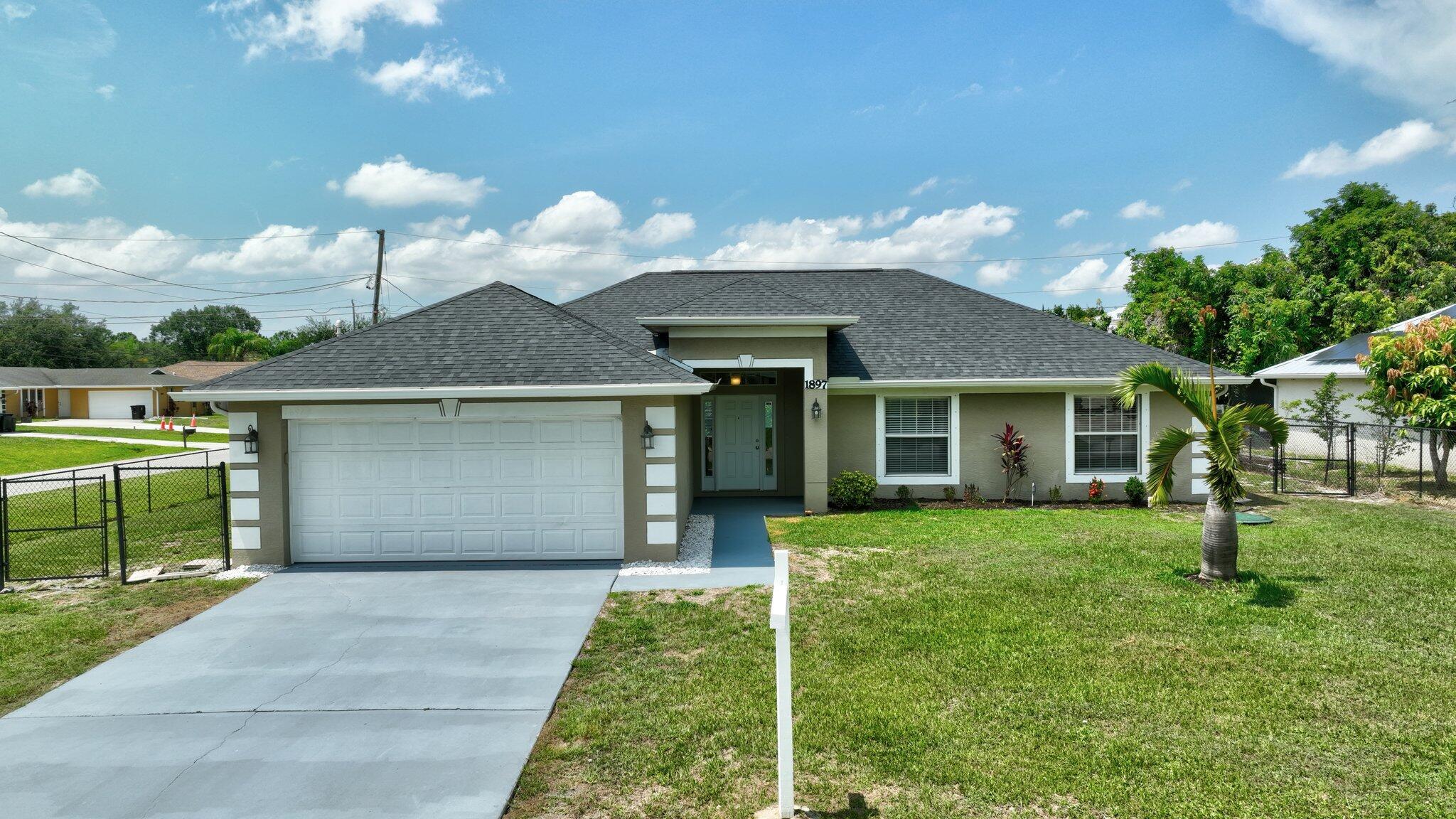 Welcome home to this beautiful 4-bedroom, 2-bath, 2-car garage gem situated on a spacious fenced corner lot! This home boasts a NEW ROOF (2024), newer A/C, and newer water heater for peace of mind. Step inside to find tile flooring throughout, an updated kitchen and open layout filled with natural light, and plenty of space for everyday living and entertaining. The split-bedroom design offers privacy for everyone. Ideally located just minutes from I-95, top-rated schools, shopping, dining, and entertainment--this one checks all the boxes!*TAXES SHOWN ARE NOT HOMESTEADED*