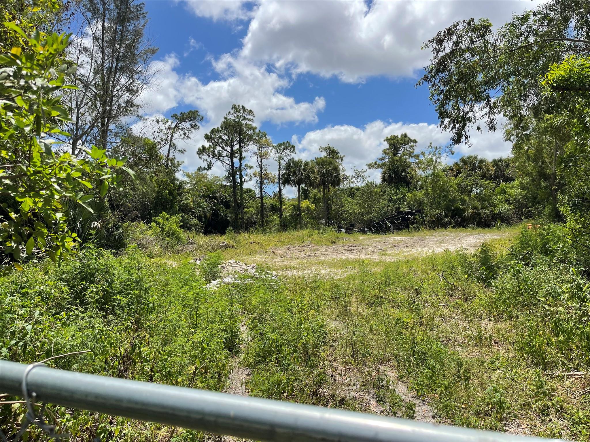 Imagine the possibilities! This exceptional one-acre vacant lot in Lake Worth presents a blank canvas for you to design and build your dream home. Nestled in Palm Beach Ranchettes, this property offers a sense of privacy and serenity that's hard to find. With a full acre at your disposal, you have the freedom to design a home that perfectly reflects your style and needs. Sprawling ranch, airy contemporary, or a classic colonial - the choice is yours!
Picture large, light-filled rooms, a chef's kitchen ideal for entertaining, and a dedicated home theater for movie nights. Design your dream backyard! Imagine a sparkling pool with a lush green lawn for barbecues . There's ample room for a playground for the kids, a firepit for cozy evenings under the stars, or even a home vegetable garden.