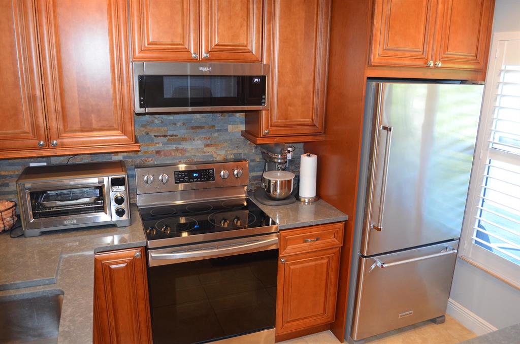 Here it is, the one you've been waiting for. Immaculate completely remodeled 2/2 in wonderful Las Verdes. Tucked away in the back of the community this villa has been turned into a retirees paradise. Gorgeous new kitchen w/ large open view to dining/living area. Tall cabinets w/ tons of storage space, Quartz Countertops w/ extension counter nook for extra workspace, all newer stainless appliances & under cabinet lighting to accent this chef's dream work space. Bathrooms have been turned into modern oasis as well as a private paver patio to enjoy those cooler winter evenings. Fresh clean tile throughout, level family/den room w/ Murphy Bed, Hurricane windows w/ new Plantation Shutters on all, new AC w/ Halo Purification system. New Laundry, New Garage Door Opener. Too much to list, MUST SE