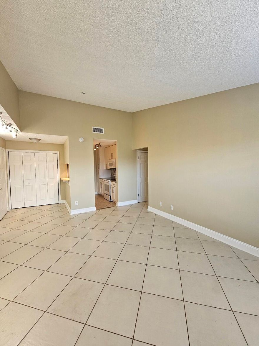 Bright and beautifully remodeled 2BR/1BA unit featuring vaulted ceilings and tons of natural light! Enjoy tile flooring in the main living areas and laminate in the bedrooms. Spacious primary suite offers a large walk-in closet. Updated kitchen boasts newer countertops, cabinetry, and stylish tile backsplash. Renovated bathroom with modern vanity, fixtures, and tile. Full-size washer & dryer in unit plus exceptional storage with multiple closets throughout. Relax on the screened, tiled patio overlooking a peaceful canal view, complete with additional storage. Situated in a fully renovated community with freshly painted buildings and a modern new look. Impact windows throughout provide added safety, efficiency, and peace of mind.