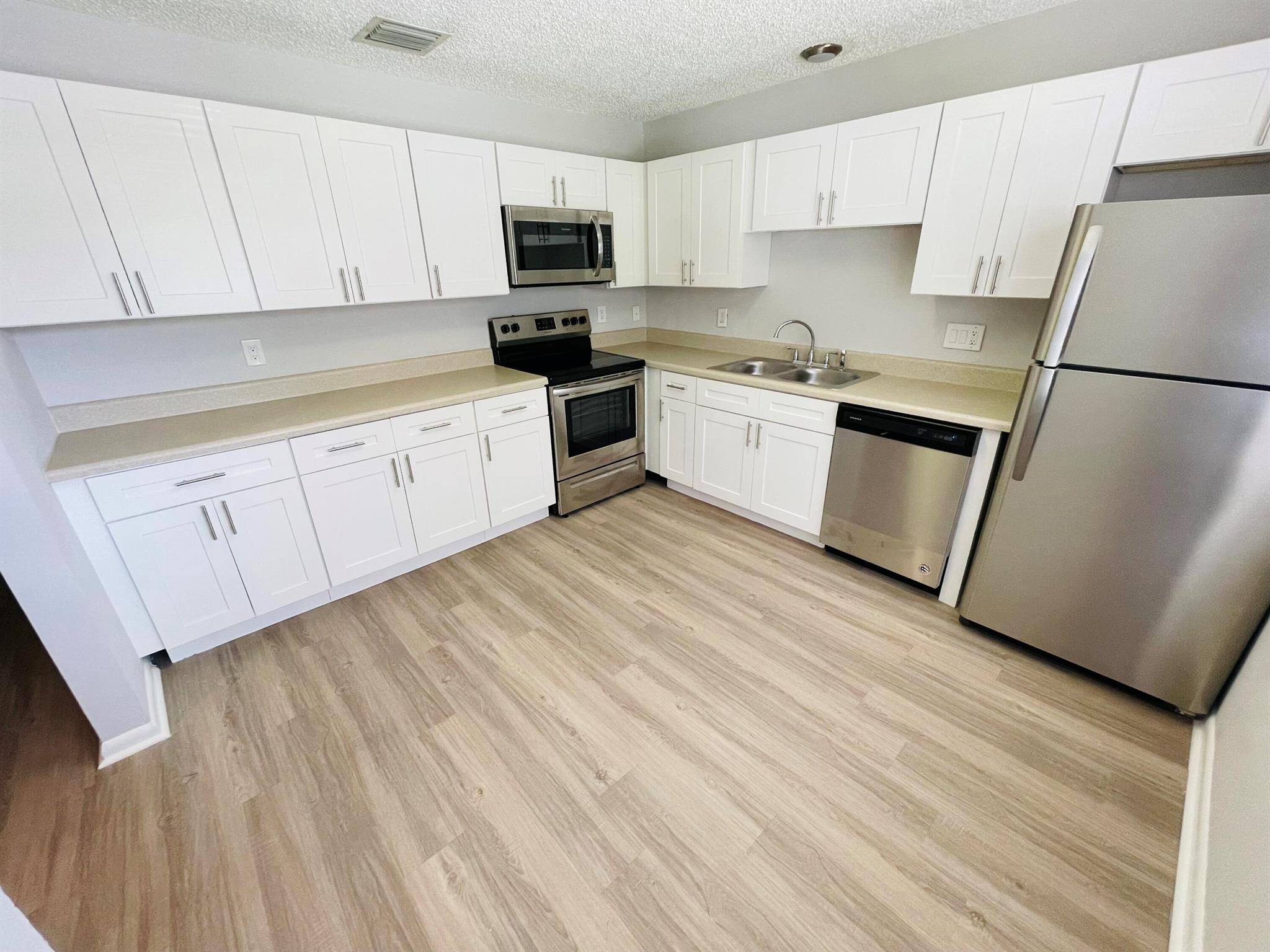 1 MONTH FREE RENT! Completely Renovated villa with 2 bedrooms & 2 beautifully renovated bathrooms. Brand new kitchen with white shaker custom cabinetry, plank flooring, brand new appliances, new bathrooms with custom vanities, new fixtures, all freshly painted thru out. PRIVATE BACKYARD AREA to spread out and enjoy south Florida living at its best. Front and rear private terraces provide great outdoor space and the interior has 13 ft vaulted ceilings. This is a MUST SEE, the biggest unit available for the price. Come today! Located near Northlake Blvd, close to beaches, shopping, restaurants, easy access to 95, only 10 minutes north of downtown West Palm Beach. Washer/Dryer inside unit. Additional monthly maintenance fee of $75 for pest/trash/common area, $145 lease transaction fee