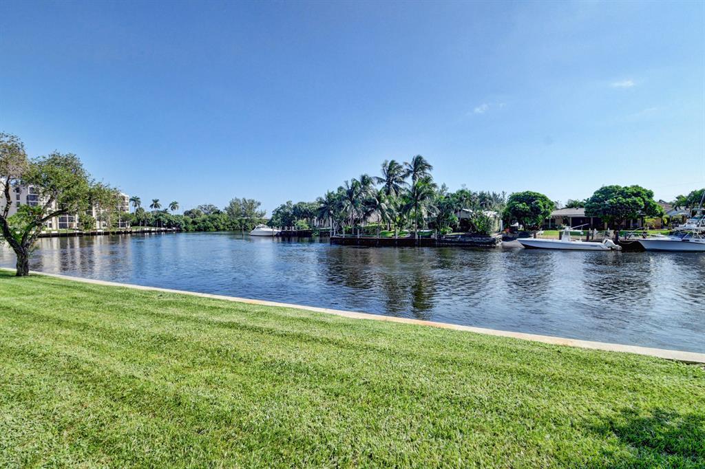 Captivating water views the moment you enter this beautifully 2/2 condo. It doesn't get any better than this! Convenient 1st floor location with parking right at your front door. UPDATED gorgeous open concept kitchen featuring granite counters, new stainless appls & snack bar. Tile throughout. Largest deluxe model w/split bedrms. Master with walk in closet. Screened patio overlooking the wide Hillsboro Canal, enjoy a boat parade everyday! Community offers 5 heated swimming pools, boat dockage, tennis courts and exercise rooms and clubhouse. Close to shopping, restaurants and beaches. Rent includes: manned-guard gated community, water, hot water, and basic cable w/HBOs. This is an all age community. Rules state: No pets allowed, no pickup trucks, commercial vehicles, motorcycles allowed.