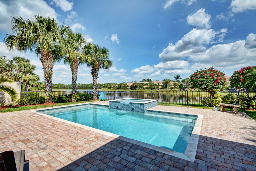 Absolutely breathtaking long, wide panoramic water views from this east-facing private corner lot. The extensive rear backyard is perfect for entertaining large gatherings and has a NEW Salt Water Pool & Spa. The landscaping has recently been upgraded with gorgeous new palms, sod and extensive lighting. Enter this exceptional contemporary-style home through the landscaped lanai with front gate and double entry opaque doors.  The wide open views greet you throughout this meticulously maintained Malaga model. Light and bright with neutral tile throughout living areas and wood floors in bedrooms and office.
Gourmet kitchen with rich wood cabinets blushed with tasteful slate tile accents and stainless steel appliances, under cabinet lighting and pendant lighting adorn the black granite. Newer fixtures and fans adorn each and every room, as well as decorative ceilings featuring 7+ inch custom crown and double crown moldings.
All sliders have been replaced with French Doors and side yard has been filled with decorative river rock and stepping stones.
New A/C system in 2017, new Epoxy flex garage floor coating and surround sound speakers inside and out are just a few on the notable additional features in this beautiful home.

Enjoy the premier lifestyle at Mirasol Country Club with two champion golf courses, state of the art practice range and facilities, 15 clay tennis courts, new full service spa and fitness center beyond anyone's expectations, aquatics center, family (kids) sports complex encouraging for young members, newly renovated clubhouse, numerous dining options including private Solstice steakhouse and year round social events.  Sports Equity Membership. One time capital contribution of $2,000.00 to the Mirasol Master Association due at closing from the buyer.