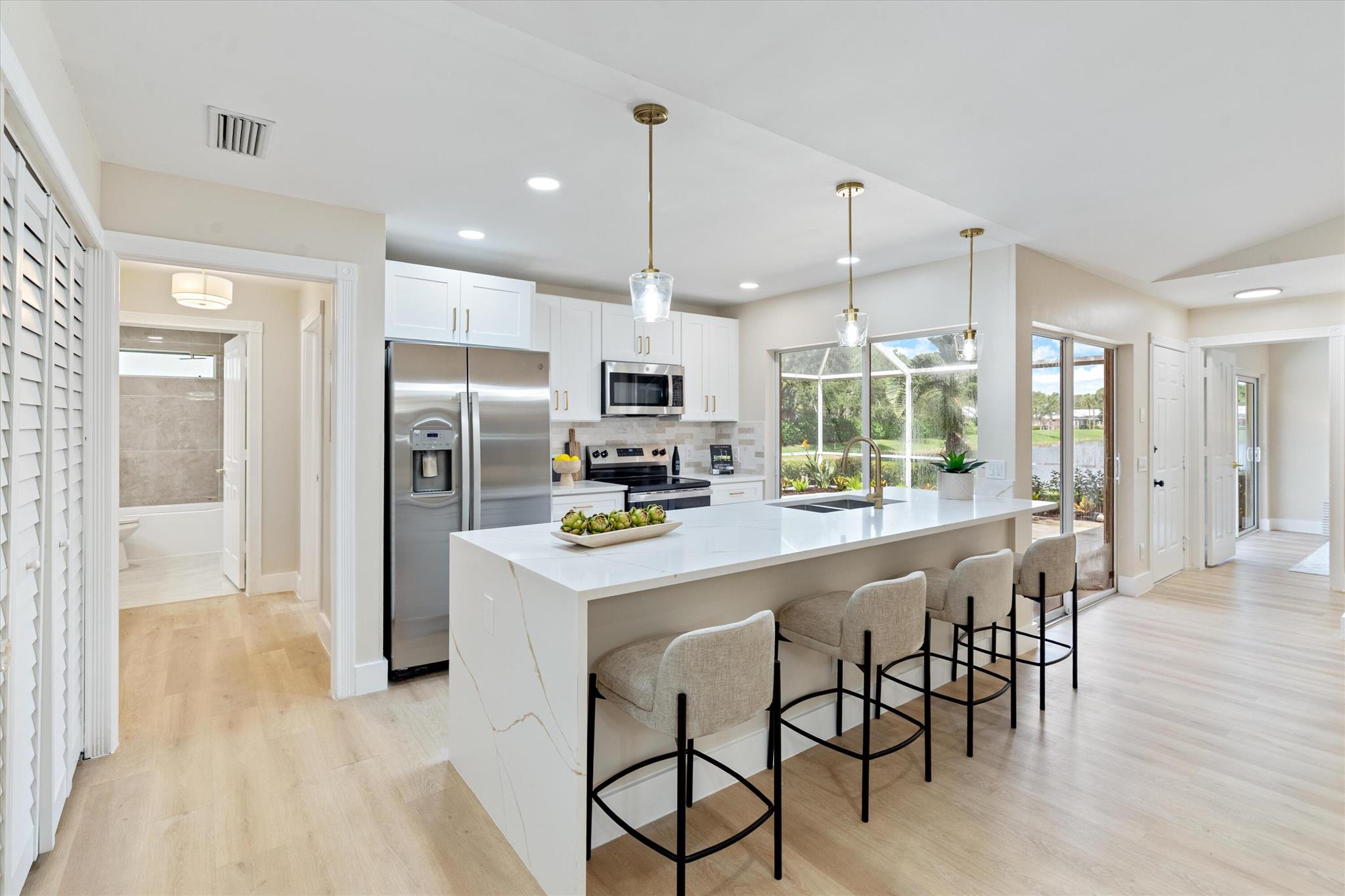 Luxurious Private Oasis. This home is a retreat escape. There are no neighbors around so that gives you unobstructed views of the water and a very expansive grass yard. The home has been updated with a brand-new AC and handler and every other appliance inside. The kitchen is updated with quartz crystal and opened up to have all light flowing through the home. There are custom built in closets in every room. Bathrooms shine for themselves, fully updated and modern. YOU WILL NOT FIND ANOTHER townhome like this one at this price in palm beach gardens.