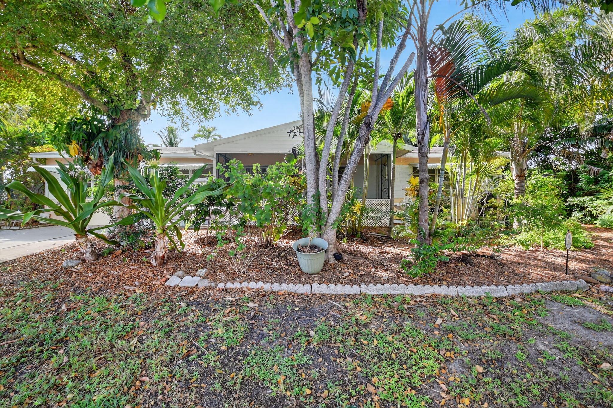 This Freshly Updated 3 Bed, 2 Bath Bungalow is a Cozy Tropical Oasis in desirable Lake Osborne neighorhood. With refinished Terrazzo floors and large windows that brings in the Sunshine with lots of mature vegetation, this home reminds you that you are living in Florida. Split floor plan with large Main Bedroom Suite with Den, large Living Space and Sliders that overlook the backyard filled with Ferns, Palms and colorful Boganivillea vines. Galley Kitchen with a Utility Room w/ full size Washer/Dryer. Great Location, just 1 Blk away from Lake Osborne for boating, fishing, paddleboarding and relaxing walks in John Prince Park, a 730-acre outdoor activity spot. Beach and Downtown Lake Worth Entertainment District is a 10 min drive.