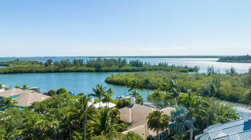 Spectacular river views and beautiful details define this 3800 sft home that appeals to both formal and casual  coastal lifestyles. Seamless indoor - outdoor living with three covered porches and a screened pool/spa.  The Chef's kitchen opens to the 'River' room for casual living and large gatherings also complemented by the adjacent formal dining and living rooms. The home features 12+ft coffered ceilings, a 9.5 ft elevation and a private dock w/ lift.  The 3 ensuite bedrooms are enhanced by the office/den next to the full Cabana Bath.  This exceptional home is situated in a prestigious guard gated HOA w/ mature oak trees, large lots, deeded beach access to Vero's best beach and close to our popular island 'Village' destination! Make it your Private Paradise!