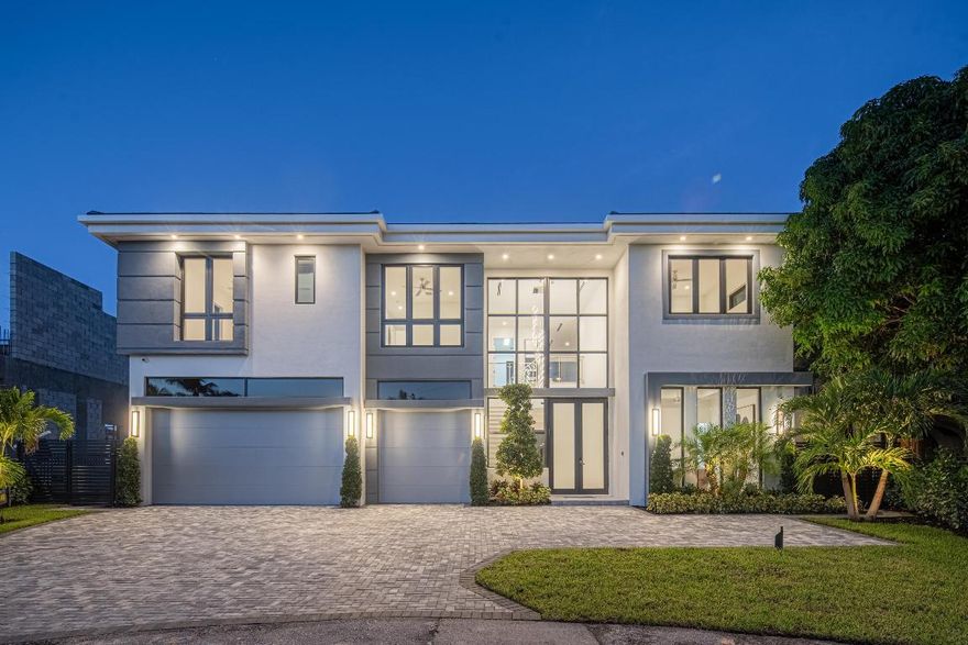 This extraordinary two-story waterfront estate is purpose-built for those who live life by the tide. Perfectly situated in the heart of East Boca Raton, you're just a 10-minute drive to the iconic Boca Raton Resort & Club, 5 minutes to the beaches, and only 10 minutes by boat to Lake Boca and the Boca Inlet—putting the best of South Florida at your fingertips.
With bold architectural lines and nearly uninterrupted walls of glass, the home captures open water views from almost every angle—an ever-changing backdrop of sunrises, sunsets, and everything in between.
Inside, the vibe is effortlessly elevated. The expansive open-concept layout blends living, dining, and kitchen spaces into one seamless, sunlit canvas—perfect for casual lounging or lively entertaining. Adjacent to the main gathering space, a sleek waterfront clubroom invites post-boat cocktails, game nights, or simply a quiet moment to unwind while the water glistens just outside.

The main floor also hosts a private guest suite (or home office, or captain's quartersyour call), offering flexibility and seclusion. When it's time to head upstairs, the elevator makes it easy. There you'll find a second living area that opens to a private balcony with panoramic views, plus four additional ensuite bedroomseach with oversized, custom closets and sweeping water vistas.

The primary suite is the showstoppera serene waterfront retreat with dual water closets, a spa-sized shower overlooking the Intracoastal, and generous dressing areas fit for both function and fashion.

Outdoors, the luxury continues: a sparkling pool, relaxing spa, and a 60' Trex dock outfitted with concrete pilings, accent lighting, and full electrical serviceready for your boat, jet skis, or weekend toys. Whether you're setting sail or staying dockside with a drink in hand, this home delivers the perfect blend of elegance, comfort, and coastal adventureall in one of Boca's most coveted waterfront locations.

Home is complete with a whole home generator, pool with salt system and heater, Wolf & Subzero appliances, summer kitchen, all custom closets, shade control, and much more.