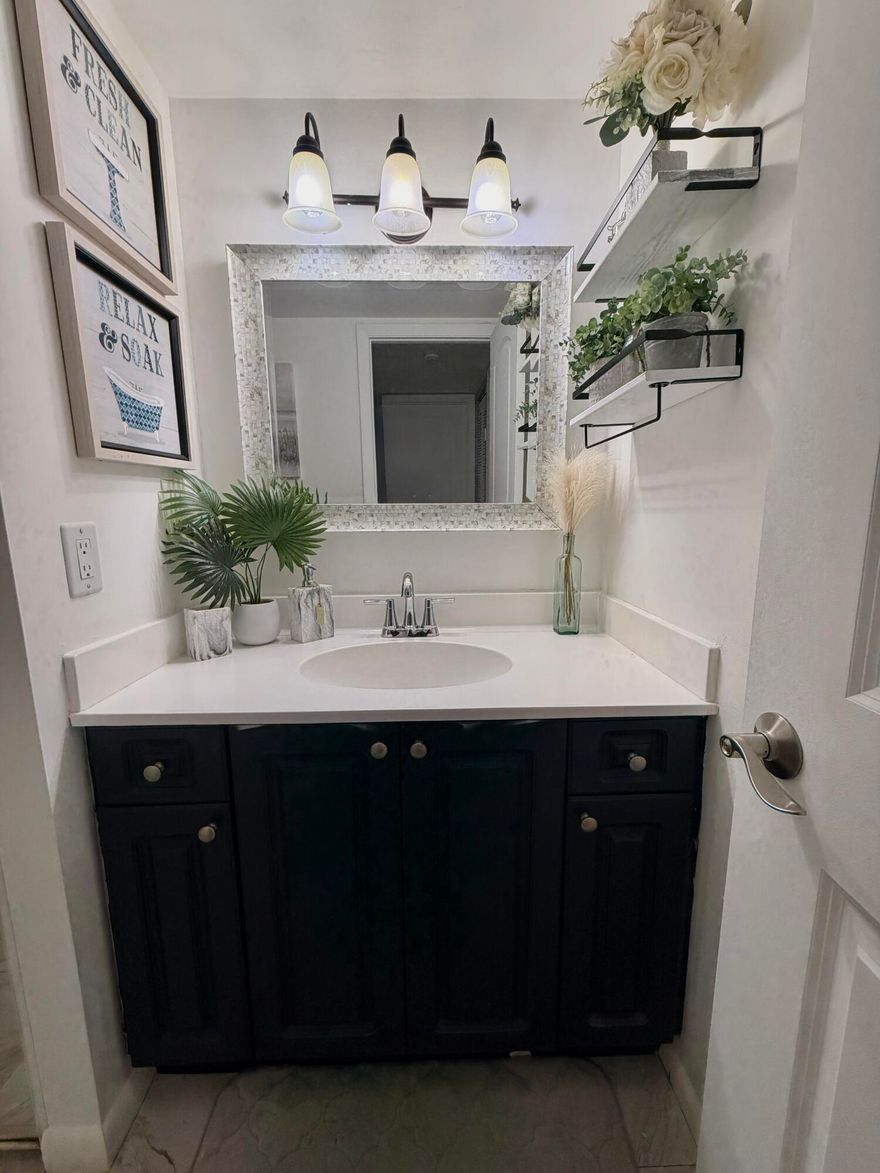 Experience elevated living in this beautifully reimagined 2-bedroom, 2.5-bathroom waterfront townhouse. Designed with a modern aesthetic, the home features an open-concept layout that seamlessly blends contemporary elegance with warm, natural tones. Every detail has been thoughtfully updated, including upgraded kitchen with stylish pendant lighting, wood-look flooring upstairs, tile downstairs. luxuriously renovated bathrooms.  Full size washer and dryer for convenience, walk in closet in primary suite  enhances the space. Enjoy indoor-outdoor living with a spacious court yard and two private balconies—perfect for relaxing or entertaining while taking in serene water views.  This move-in-ready property is the perfect blend of style, comfort, and location. Located in the desirable Village of Sandalwood community, residents have access to resort-style amenities including three pools, basketball and tennis courts, pickleball, sand volleyball, and scenic exercise trails. The HOA conveniently covers cable, internet, water, sewer, and trash, adding exceptional value. Ideally situated just minutes from Downtown West Palm Beach, this home offers easy access to top dining, shopping, parks, and the airport.