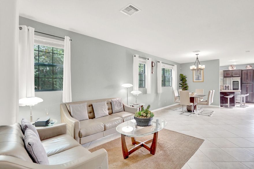 Situated within the prestigious Gramercy Square community, this sought-after corner lakefront 3BR/2.5BA townhome, with garage, offers tranquility, privacy, and elevated living. Enjoy a spacious living/dining area, open kitchen with serene nature views, and private patio for birdwatching with lakefront sunsets. Upgrades include vinyl and tile flooring plus impact windows and doors. The generous primary suite overlooks the shimmering lake and fountain, featuring dual closets, and a Roman tub. All-ages & pet-friendly, residents enjoy resort-style amenities including a heated pool, fitness center, and playground. Close to downtown Delray, Lake Ida Park, Sprouts, Aldi, Publix & farmers markets. The HOA covers roof, exterior insurance, cable, internet, and lawn care. No rental restrictions.