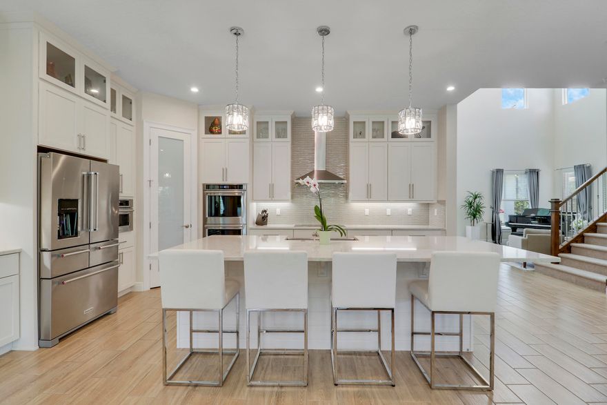 PRIVACY ABOUNDS IN THIS CUL-DE-SAC POOL HOME NESTLED ON AN OVERIZED LOT IN THE WATERFRONT COMMUNITY OF LANGFORD LANDING! This spacious 5BR+Loft/5.5BA/3CG home has over 4200 square feet of living space, a private pool & spa and comes with a 50' BOAT SLIP!! First impressions are everything and the moment you step through the front door you will begin to appreciate the many special features of this home! Grand foyer & formal living area w/ soaring ceilings and beautiful staircase, flowing great-room plan, upgraded tile flooring t/o living areas, gourmet kitchen w/ high custom cabinets, island w/ breakfast bar, quartz counters, stainless steel appliances, pantry & dining area. Main level also includes a full bedroom bathroom - perfect for guests, visiting relatives or as a home office. The stairs lead up to the loft area with engineered wood flooring and is the ideal flex space suitable for many uses including game room, movie space or an exercise area. The master suite with double door entry is a private retreat with incredible SPA-LIKE ENSUITE featuring dual vanities, free-standing soaking tub and double 'walk-through' tiled shower. Large walk-in closet and access out to private balcony overlooking the preserve. The second level is completed with three other bedrooms (all with access to their own bathrooms) and a convenient laundry area with utility sink. THIS HOME HAS IT ALL including your own PRIVATE BACKYARD OASIS complete with tropical landscaping, inground heated pool & spa, outdoor shower, summer kitchen, fenced backyard and serene views over the preserve! Other home highlights include energy efficient features, tech room, wet bar, designer lighting, IMPACT GLASS WINDOWS & DOORS and a spacious 3 car garage! The built-in hall tree by the garage entry is the perfect area for hats, purses, back packs and more! Langford Landing is perfectly situated in Jensen Beach! Its waterfront location provides direct access to the St. Lucie River and Stuart Inlet.  Historic downtown Stuart's shops, restaurants and boutiques are just a short drive or boat ride away! Call today to view this beautiful home!