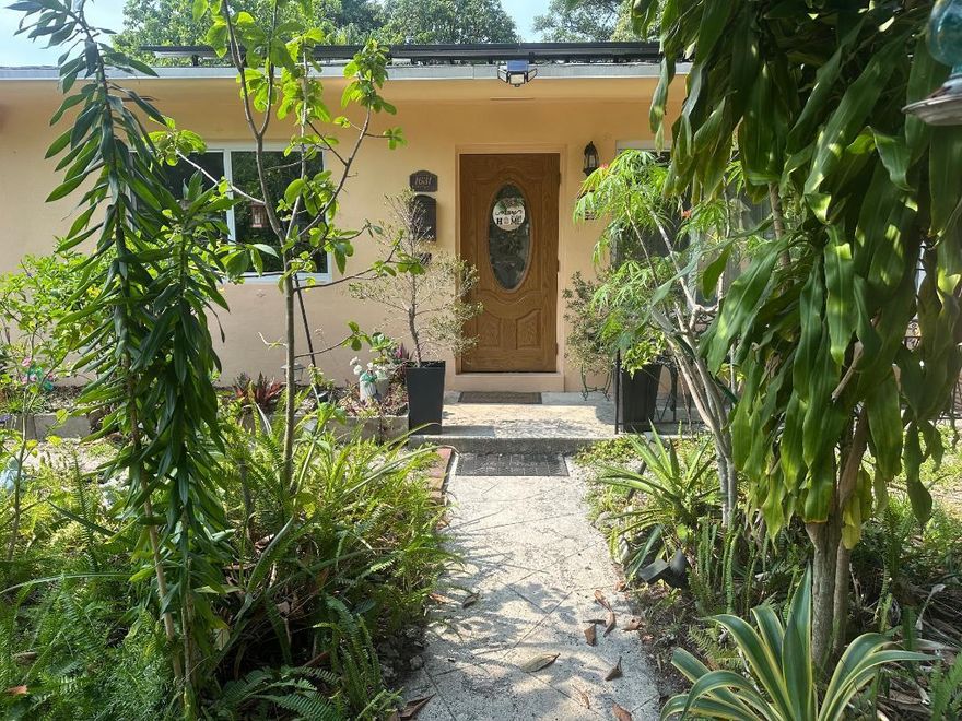 First time for sale in 30 years. 3 bedroom, 2 baths with a Florida room, porch patio in the back overlooking a huge yard consisting of lush array of fruit trees and plants. New roof, 2023, Solar panels (paid) that keeps a low FPL monthly payment, Updated kitchen with granite countertops and stainless-steel appliances. Separate laundry room, updated bathrooms and impact windows throughout. 10,000 square foot lot, 4 mango trees, papaya, orange, loquat, moringa and much more. Interior pictures to come closer to being active.  Updated 3/2 on a 10k square foot lot with lots of fruit trees.
