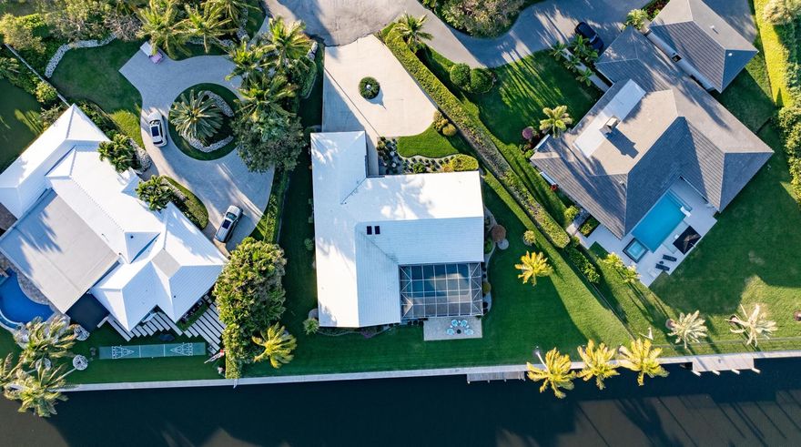 Enjoy as is, or re-envision, expand or rebuild. This Gulf Stream residence has 200 feet on the Intracoastal Waterway on a cul-de-sac lot of almost three-quarters of an acre. Views are unrivaled. The great room and primary bedrooms access the covered loggia and pool surveying serene sunrise views over the water to lush tropical landscaping that edges the exclusive private Gulf Stream Golf Course.