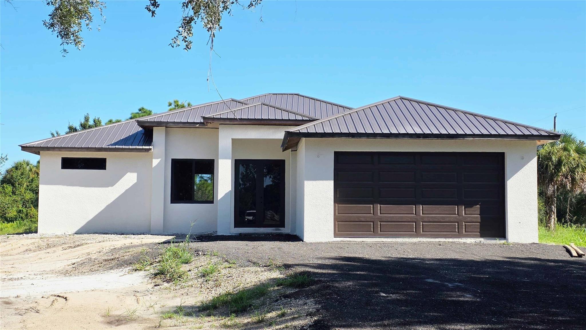 Check out this GORGEOUS AND BEATIFUL HOME IN Montura Ranch, Clewiston FL.  PAVED DRIVEWAY. No expense and good taste have been spared in this property, with three bedrooms, and two bathrooms. Kitchen with new stainless steel appliances, ATTRACTIVE DESIGNER CHOICES in flooring, cabinetry, granite counterstop, lighting & fans, and impact windows. The house sits on a private corner 1.25 Acres lot, giving you the perfect space for Games AND Outdoor EntertaininG. Space for you and your family, in the middle of the birdsong, but still close to the city. Enjoy the warm exposure, gentle breezes, swaying palm fronds, and birdsong in your private oasis.  THIS BEAUTIFUL HOME WILL NOT LAST! NO HOA. HOME IS EXPECTED TO BE COMPLETED BY November