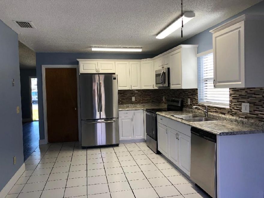 New kitchen cabinets, counter top, new refrigerator, stove, dishwasher, microwave, new window blinds, new washer/dryer in garage... Pet deposit $200 non -refundable.  Renters are responsible for all lawn front and back., installation and installation storm shutters, personal renter insurance. 
If the length of rent is less than one year,  charge 2400 per month.