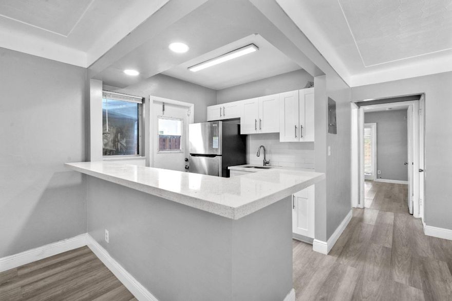 THIS IS IT! Both sides are currently rented until approx March 2026.  Duplex completely remodeled! One side is a 2/2 with its own private backyard.  The other side is a 1/1 with its own private backyard as well! Both units have their own washer and dryers.  APPRX 1 MILE FROM THE BEACH!  Both units have been substantially REMODELED with Commerical Grade Waterproof laminate floors. New Kitchens with Quartz countertops.