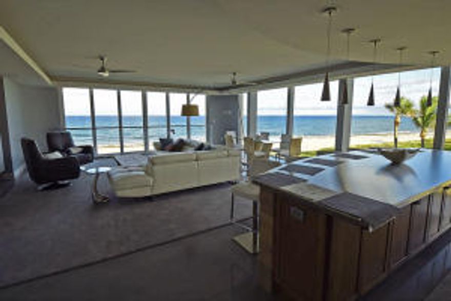 Only a very few are lucky enough to live right on the beach! Be the first to experience 180 degree expansive ocean views from almost every room in this newly remodeled, corner unit condo with brand new floor-to-ceiling hurricane impact windows. The home features a brand new custom kitchen with granite countertops and Thermadore stainless steel appliances.  The master suite has two walk-in closets and its own private ensuite bathroom.  The master bath has a double vanity, make-up table, and a large free-standing soaking tub sitting directly under a skylight. The spa-like shower features a rainshower head, a shower wand and adjustable body sprays.  Three of the four bedrooms have ocean views, large closets and ample storage.  All bedrooms have ensuite bathrooms except one.