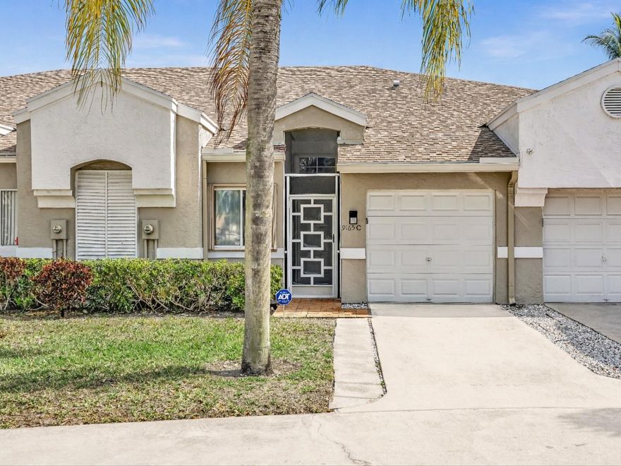 Welcome to this charming villa in Boca Raton's highly sought-after ''Boca Gardens''. This 2-bedroom, 2-bath split floor plan offers 1,404 square feet of air-conditioned living space, highlighted by soaring vaulted ceilings that create an open, airy ambiance. The home features ceramic tile in main areas with warm wood-laminate flooring in bedrooms, and a spacious primary suite with a large walk-in fitted closet and expansive ensuite bath.  Enjoy peace of mind with a brand-new LG French Door refrigerator, Roof in 2023, A/C in 2020, full accordion storm protection, and upgraded ADT alarm system.  Complete with a 1-car attached garage, in-unit washer/dryer, and A-rated Boca Raton schools - this home is ready for your design vision, personal touches and improvements!