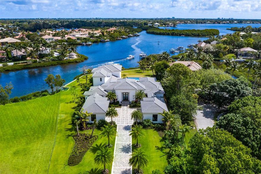 SPECTACULAR from the minute you drive through your private gated entry! This amazing Custom-Built riverfront home was newly built in 2018 with no expense spared, located on over 1.2 acres with 190' of waterfrontage and South East exposure with mesmerizing views. This home boasts designer finishes by Decorators Unlimited and unsurpassed craftsmanship throughout, including state-of-the-art smart house fully automated Crestron System that controls lighting, blinds, security and more. All CBS construction with Epicore, structural floor system over kitchen & poured concrete 2nd floor, Impact windows/doors, Icenyne insulation and full house generator. For the gourmet cook the kitchen offers a large island, two 36'' Sub Zero refrigerators w/4 freezer drawers, Wolf double-oven, see more.. Meile steamer and built-in coffee maker, microwave, 48" 6 burner Wolf gas cooktop w/grill and two Meile dishwashers. For entertaining, there is a beautiful wet bar w/Scotsman's icemaker, wine cooler and an additional bar area with two tall Subzero wine coolers overlooking a beautiful open family room. The master suite is located on the first floor and includes separate His-and-Her bathrooms with large walk-in closets.
Step outside and relax under the large covered lanai and enjoy beautiful river views while entertaining at your summer kitchen w/ Alfresco gas grill, refrigerator & Icemaker as well as a gas linear fireplace. All of this overlooks a magnificent luxury resort style oversized heated pool with spa and large marble deck complete with fire bowls. Boating, fishing, paddle boarding is right in your backyard w/private dock and boat lift just minutes to the Jupiter Inlet and all that Jupiter has to offer.
For the car enthusiast there are two attached 3 car air-conditioned garages for a total of 6. If you would like to add to your car collection you can stack with lifts as each of the 3 car garages have 12' ceilings. To many additional features to list. 
* Adjacent Lot also available for sale and listed at $1,800,000 if you would like more privacy 2 1/4 acres and more waterfrontage. MLS:RX-10612888 - SOLD PRICE INCLUDED RX-10612888