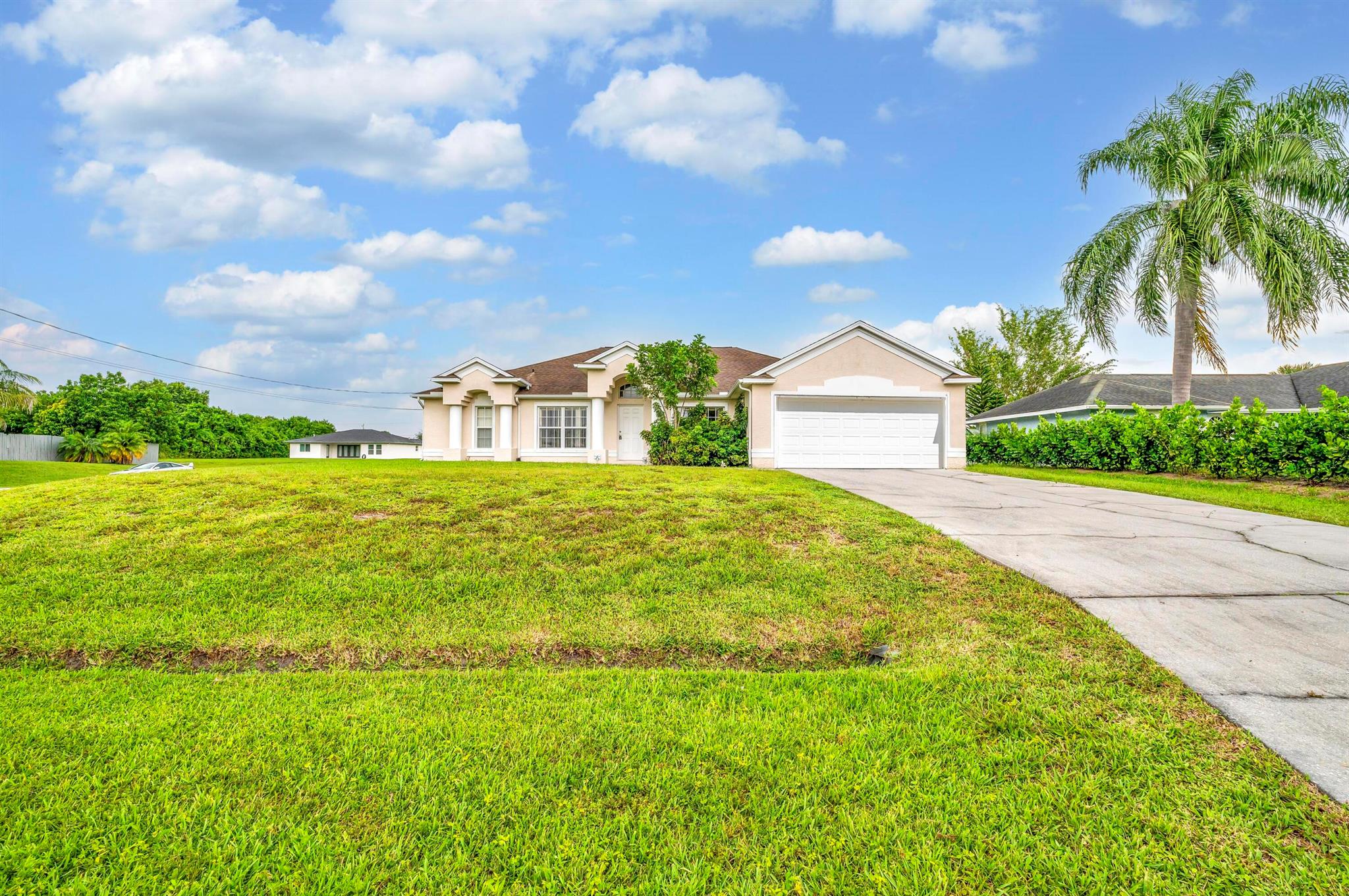 Come take a look at this beautiful home just minutes to I95! NEW ROOF & NEW FENCE! This home sits on an oversized CORNER LOT with a canal in the back. New wood flooring in the living room and master bedroom. The house has a split floor plan with a formal living room, formal dining room and a separate laundry room. Master bathroom has dual sinks, separate shower and separate soaking tub. The master bedroom has a nice size walk in closet! Custom wood cabinetry in the kitchen and bathrooms. Full panel of hurricane shutters in the garage. Nice size patio in the back yard.