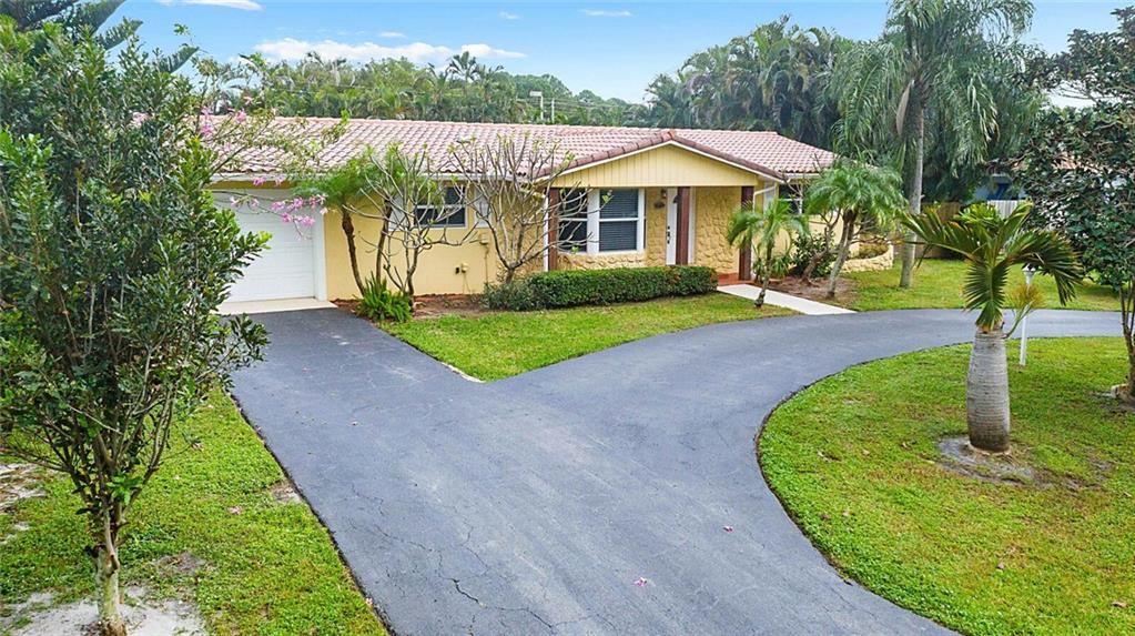 Living is easy in this upgraded 3/2 home in Chapel Hill. A rare find in this quiet part of Boynton. The hottest little neighborhood in S Palm Bch County. Just minutes from the beach, highways, shopping & great schools. This beauty sits on oversized fenced lot, over 1/4 acre, w/ privacy landscaping & plenty of room for barbecues, entertainment or to put a pool. Features an upgraded kitchen w/ granite countertops, stainless steel Samsung appliances & modern design. Bathrooms are also upgraded w/ modern & European style vanities, hardware, and fixtures. Flooring is contemporary tile throughout the house (no carpets here). Property also comes with large circular driveway and car garage with plenty space for at least 6 cars or more. Upgraded impact windows and closed in Florida room.