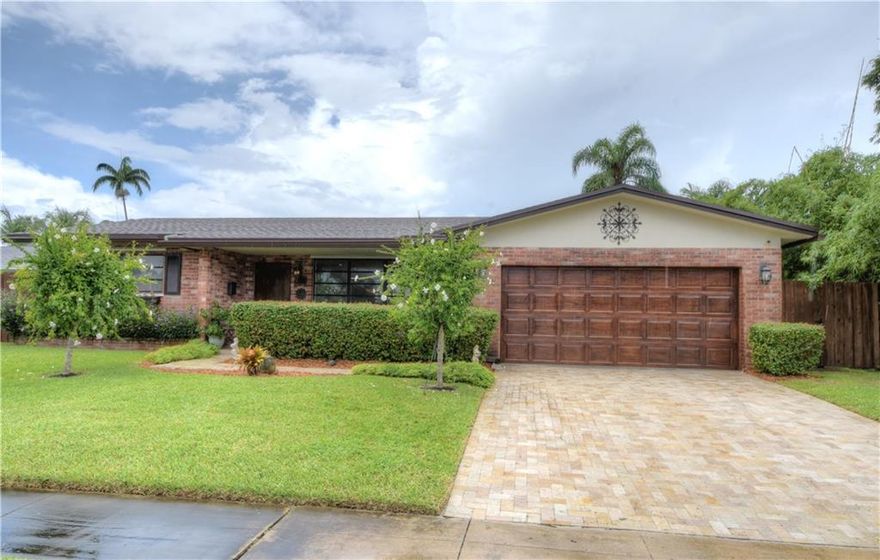 This is a fantastic Hollywood Hills home! Beautifully updated and features a open floor plan with lots of windows overlooking the resort style backyard! The kitchen features rich wood cabinets, designer granite counter tops and a cooking island! Perfect for a family gathering or a party! The bedrooms are spacious and the home features a bonus room that can be used as a family room, den or office. There is porcelain tile thru-out! The backyard is a true treasure. Beautiful sparkling pool that is heated, large covered patio & BBQ/picnic area. A terrific yard to enjoy the sunny South Florida days! The roof is less than 2 years old and AC is only 4 years old! This home is nestled on a tree lined street convenient to all highways, shopping and just minutes to the beach. This home is a must see!