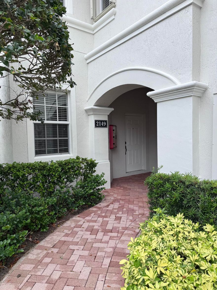 Handyman Special with Incredible Potential! Located in the highly sought-after gated community of Mayfair on Lake Wellington, this waterfront first-floor coach home offers 3 bedrooms, 2 baths, and a 1-car garage with a spacious and desirable 3-way split bedroom floor plan—perfect for privacy when family and guests are visiting. The primary suite is generously sized and features a large walk-in closet, additional wall closet, linen closet, dual sink vanity, oversized Roman soaking tub, and a separate walk-in shower for added convenience. The home also offers an eat-in kitchen with a pass-through window to the dining area, an interior laundry room, and exterior storage space. The community replaced the roofs and did exterior painting of all units in 2024 Enjoy peaceful water views from this well-positioned unit while adding your own personal touches and updates to make it shine again. Mayfair on Lake Wellington is a gated 55+ community offering wonderful amenities including a clubhouse with kitchen, fitness center, heated swimming pool, and social activities. Conveniently located in the heart of Wellington, residents enjoy being within walking distance to the Wellington Senior Center, Wellington Amphitheater, shopping, restaurants, and community events. Fantastic opportunity to create your perfect Florida retreat!