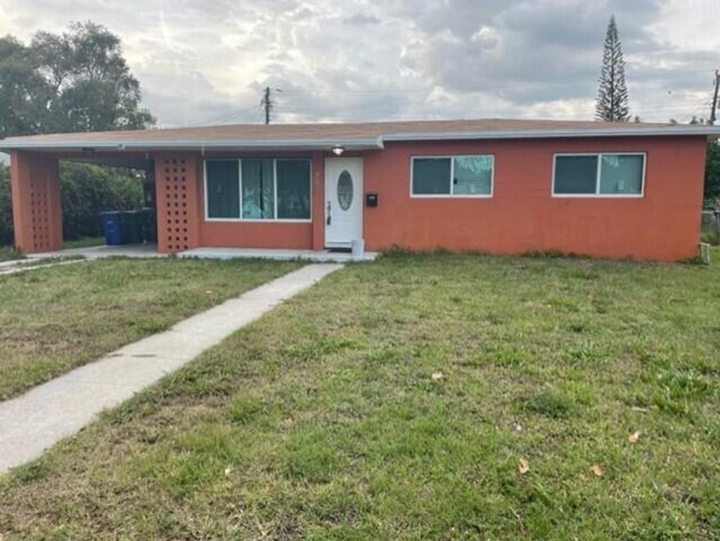 Photo of 747 Date Palm Drive, Lake Park, FL 33403 (MLS # R10790016)