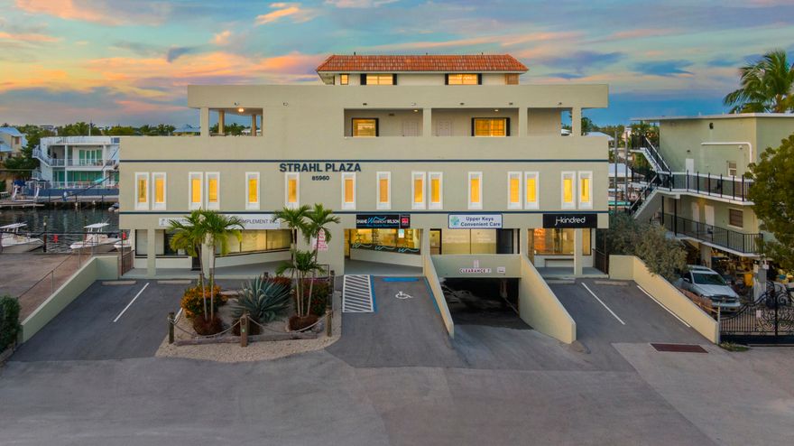 Family Owned/Never offered prior to 2021-The Strahl Plaza in Islamorada offers Retail, office, and 2 complete penthouse stories of private residential space. Add to this multiple DEP WATER boat slips with new dockage, water and power, this truly checks all boxes. 1st floor is sought after covered parking, 2nd floor offers 5 occupied retail spaces with their own entrance.   The 3rd floor housed the homeland security offices until Sept 2021 and is self contained accessible by its own locked off elevator or staircases. Perfectly suited for a medical office space or shared use- 12 offices and 2 full baths with shower facilities. next two levels of your own private living space offering open water views from all angles. Use as a living space for yourself, lease to your management team or on a monthly basis. Currently structured as a 2 bedroom 2 -1/2 bath apartment on one floor and the top open floor is your own bar, game room and captains quarters. Located seconds away from the Snake Creek bridge allowing sailboats and large boats access and dockage at the property. The Commercial space truly offers so many possibilities. Create your very own piece of paradise for work and leisure. Income producing and maintained impeccably by the current owners. Family owned since lovingly built by the owner in 1987.