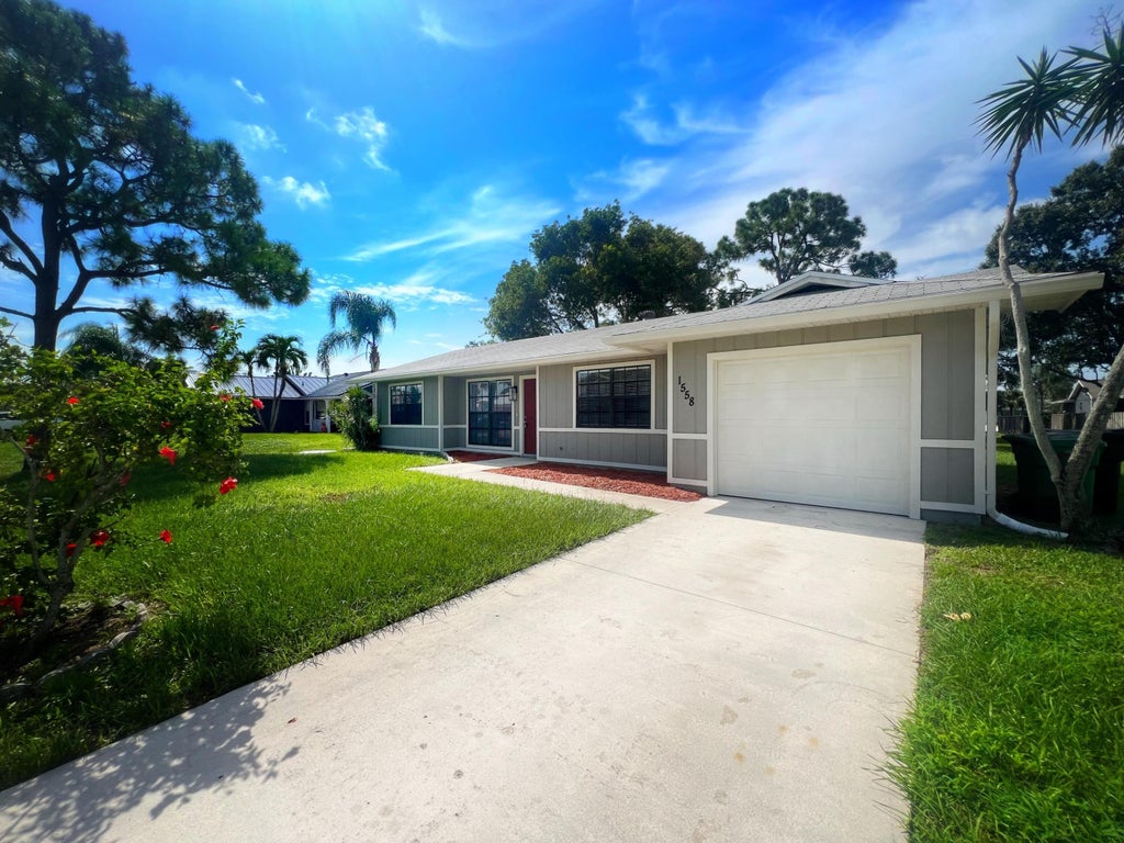 Photo of 1558 SW Silver Lane, Port Saint Lucie, FL 34953 (MLS # R11012368)