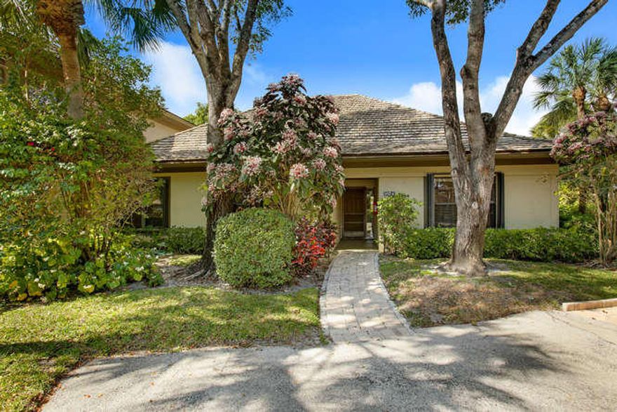 Much sought-after floor plan and location on banyan-lined Polo Island Drive. Beautifully upgraded cathedral ceiling living area, crown molding, and naturally bright throughout. Three bedrooms with en-suite baths. Master features his & her closets along with a wet bar housing a wine cooler & refrigerator. Office with custom bookcases. Enjoy sunsets, water views, and a glimpse of dressage from your beautiful screened in lanai.