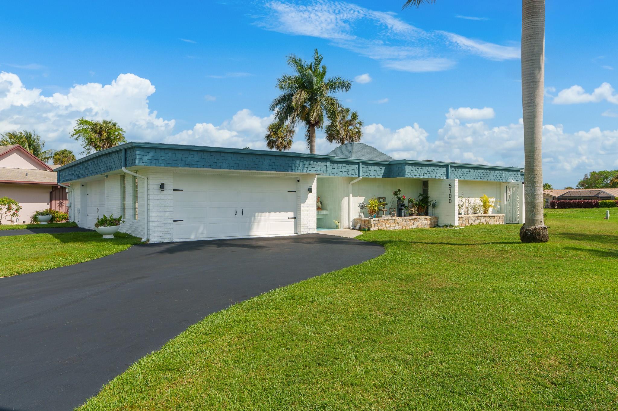 MID-CENTURY meets MODERN! This unique architectural design allows for so much natural light. Interior remodel includes 24X24 MARBLE TILE throughout, NEW KITCHEN with white shaker cabinets, SS appliances and quartz countertop/waterfall, freshly painted inside and out, Wi-Fi Smart System, updated electric, roof (2019). Split floor plan. 2 zone A/C. Open concept GREAT ROOM includes, living room, game room and formal dining room that all flow into the kitchen and screened lanai. This home is GREAT FOR ENTERTAINING! But wait, there is more - unique 4 CAR GARAGE makes for a great 800 sq. ft. "man cave", plus two driveways.