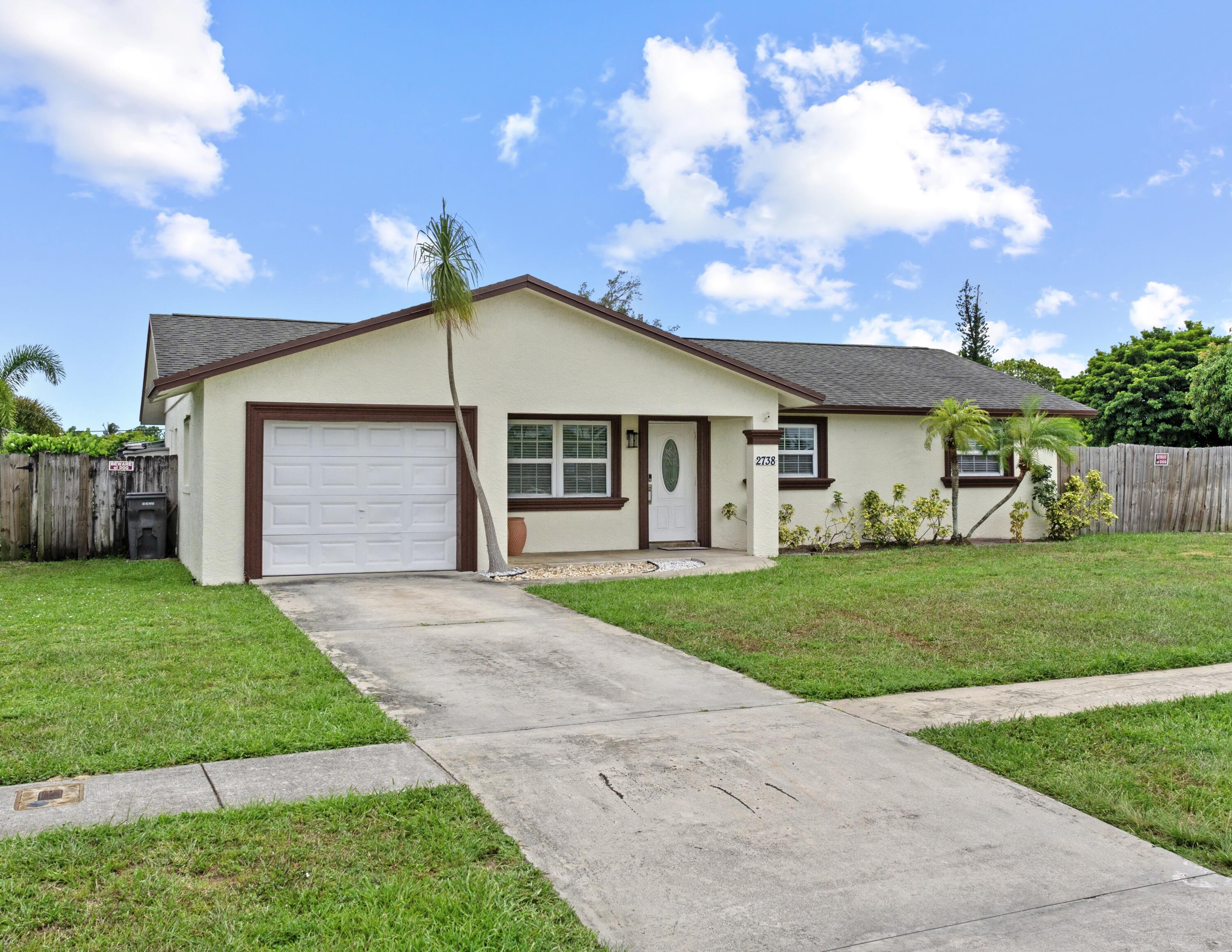 DON'T DELAY - BUY TODAY! Location, location, location! Discover this beautifully renovated 3-bedroom, 2.5-bath home in one of West Palm Beach's most desirable neighborhoods - Flamango Lakes - with NO HOA! Featuring a brand-new A/C, a fully updated kitchen with quartz countertops, Samsung appliances, and a Bluetooth-controlled range hood for modern convenience. Bathrooms have been completely remodeled, and new tile flooring flows throughout the home.Step outside to your screened, Diamond Brite swimming pool - perfect for year-round enjoyment - with an ideal setup for outdoor cooking and entertaining friends and family.