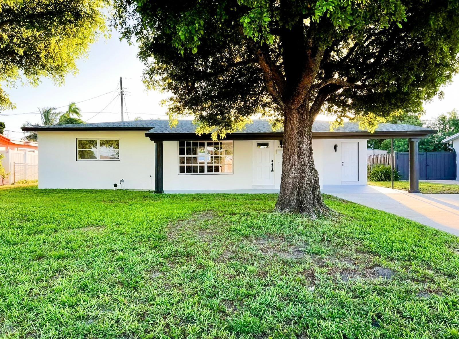Welcome to this beautifully renovated home located in the heart of Lake Worth. NO HOA! Featuring a sleek, modern design with high-end finishes throughout, this property offers 3 spacious bedrooms, 2 luxurious bathrooms, and an open-concept layout perfect for entertaining. The kitchen boasts custom cabinetry, quartz countertops, stainless steel appliances, and stylish lighting fixtures.Enjoy elegant porcelain tile flooring, updated bathrooms with frameless glass showers, and modern vanities with LED mirrors. The home is filled with natural light and opens up to a large backyard with ample space for outdoor living.