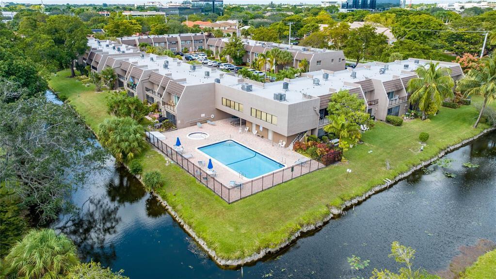 Move right in to this updated Coral Springs townhouse loaded with big-ticket upgrades! Enjoy year-round comfort with a 1-year-old A/C, 2020 water heater, and NEW in-unit washer/dryer. The sleek granite kitchen shines with a new refrigerator, double oven, and beautiful countertops. An open layout flows to a spacious suite bedroom with balcony and serene water views. Relax or entertain on the screened patio, take a dip in the community pool, and appreciate the low HOA covering water and trash. Min 10% down, 650 credit.
