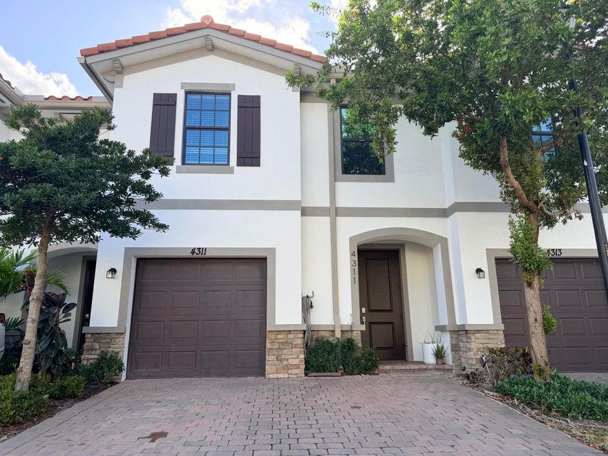 Welcome to this beautifully updated townhome nestled in the Arbor Parc community. Offering four bedrooms and two and a half baths, this home has been thoughtfully refreshed throughout making it truly move-in ready. Step inside to find newer appliances, updated finishes, and a bright, open layout designed for everyday living. Step outside to your private fenced-in back patio, complete with a custom putting green — a rare and delightful touch for the golf enthusiast or anyone seeking a serene outdoor retreat. The one-car garage adds convenience and extra storage. Ideally situated on Military Trail, just north of Blue Heron Boulevard.