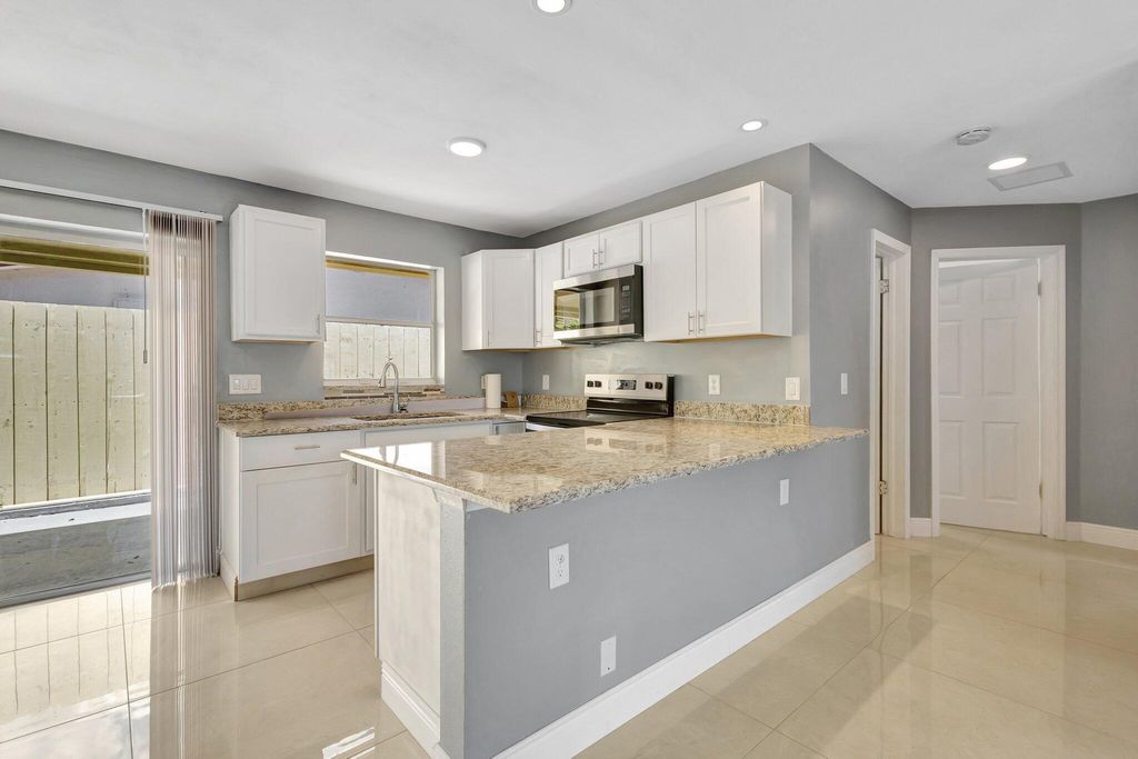 Photo of 212 Palmetto Drive, Lake Park, FL 33403 (MLS # R11091441)