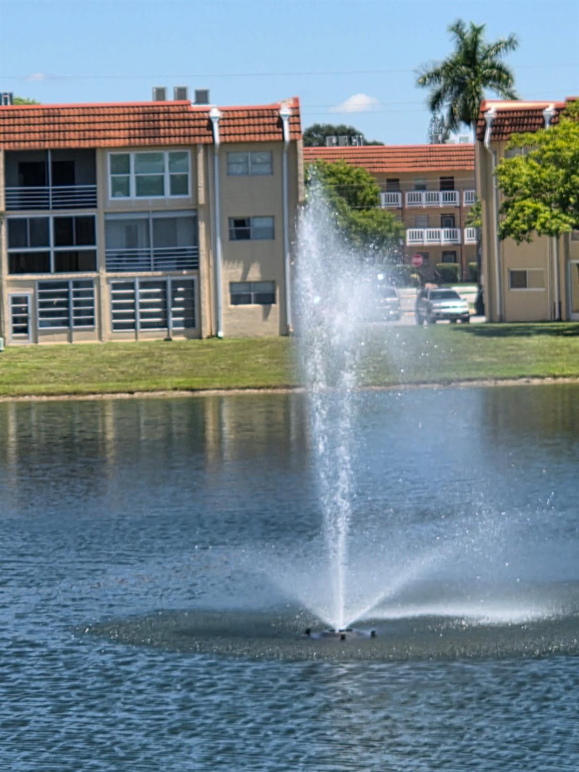Welcome to this charming 2-bedroom, 2-bathroom CORNER unit with tons of natural light , in the sought-after Sunrise Lakes III. Second floor, with AMAZING water/fountain views to soak in with your morning coffee the private screened balcony. At night the fountains are lit for further relaxation ! Assigned parking space is directly below the condo, ensuring comfort year-round. Home is move in ready with upgraded kitchen, closet doors, laminate & tile thruout for your convenience. Clubhouse steps away w/ 300 seat theater, frees movies on Tuesdays, swimming pool, tennis courts & courtesy bus. Conveniently located near shopping, dining & entertainment, this home combines comfort w accessibility. HOA: cable w/ Starz & Pride contract & fire alarm that goes directly to fire station 4 your safety.