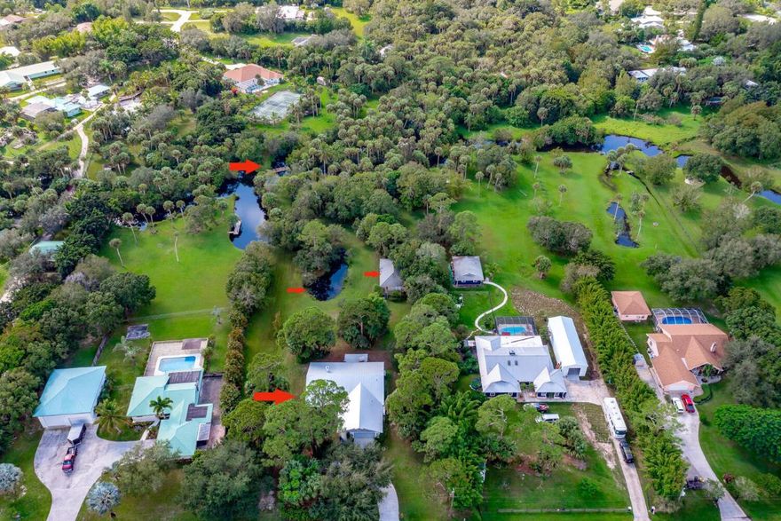 Bring the Goat and the Boat! Welcome to your in-town  country estate. The setting is fabulous, a 2.1 acres of park-like old Florida where trees & wildlife abound. Bring all of the kids & family, all of the animals, all of the toys & your boat for ocean access off your Bessey Creek dock. No HOA. Main house w/ 3 bedroom + den split plan, 2 baths. Living room w/ wood burning fireplace, formal & casual dining areas, spacious kitchen, den, & large screened porch over looking pond & expansive grounds. Main bedroom suite has flex space for  gym, sitting room or private porch to take in the view. Cottage has 2 bedrooms, bath, kitchen & living area. So much potential, so many possibilities. Designated small farm, agricultural so more freedom, less tax. You're in town, so a short hop to shop, dining , freeways, schools. Original owners, pride of ownership shines. A unicorn in a haystack. Make it your own- what ever floats your goat!
