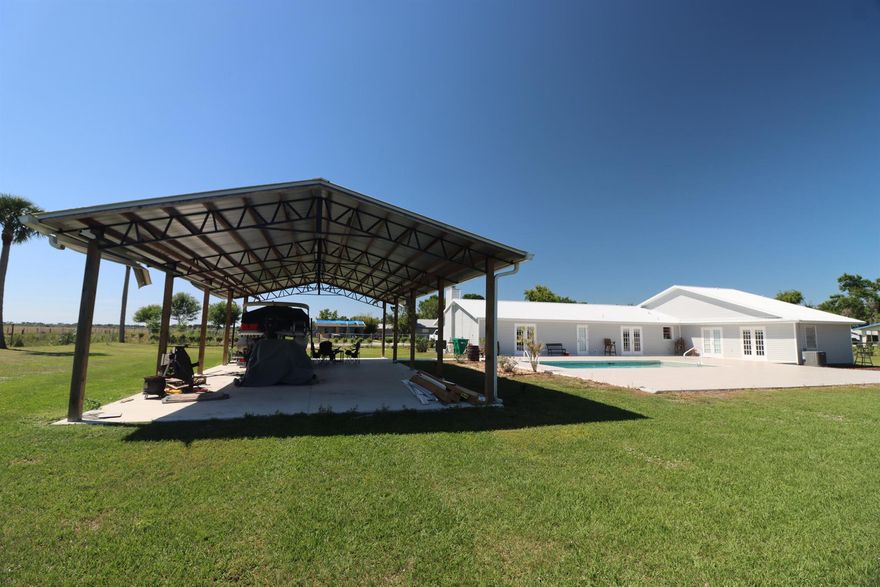 3 Bed/2 Bath + Optional 1/1 CBS cottage. Many new upgrades! 2,191 sq ft, 3,139 total living area, single family pool home on 1+ acre.  CBS cottage with new metal roof on adjoining separate double lot (.70 acre)   Main house has a new metal roof, new steel-truss 2 car-shelter, new A/C, new siding, new utility shed for water system, new 5' chain link fence with remote entry vehicle gate.  New accordion storm shutters & 24KW whole house propane generator, w 500 gal buried tank & home security system. This upgraded home features a spacious family room with fireplace, beautifully remodeled bathrooms adorn this home.  Generous size master bedroom with an on-suite bathroom that features a walk-in shower, soaking tub and dual side closet.  Large dining room with space for the whole family.