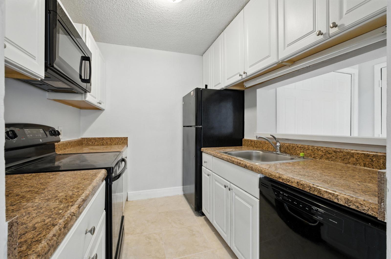Beautiful 2 bed, 2 bath condo in desirable Palm Aire Gardens! Features include tile floors throughout, spacious walk-in closet, in-unit washer/dryer, and a private balcony with extra storage. Gated community offers resort-style amenities: 2 pools, fitness center, tennis courts, clubhouse & more. Pet-friendly—2 pets up to 40 lbs each allowed. Water/sewer included in rent. Centrally located near I-95, Turnpike, shopping & dining. Investor-friendly—rent immediately for $1,800/month. Perfect for end-users or investors looking for great rental potential in a prime location! MIN 600 credit score. NO SPECIAL ASSESSMENTS