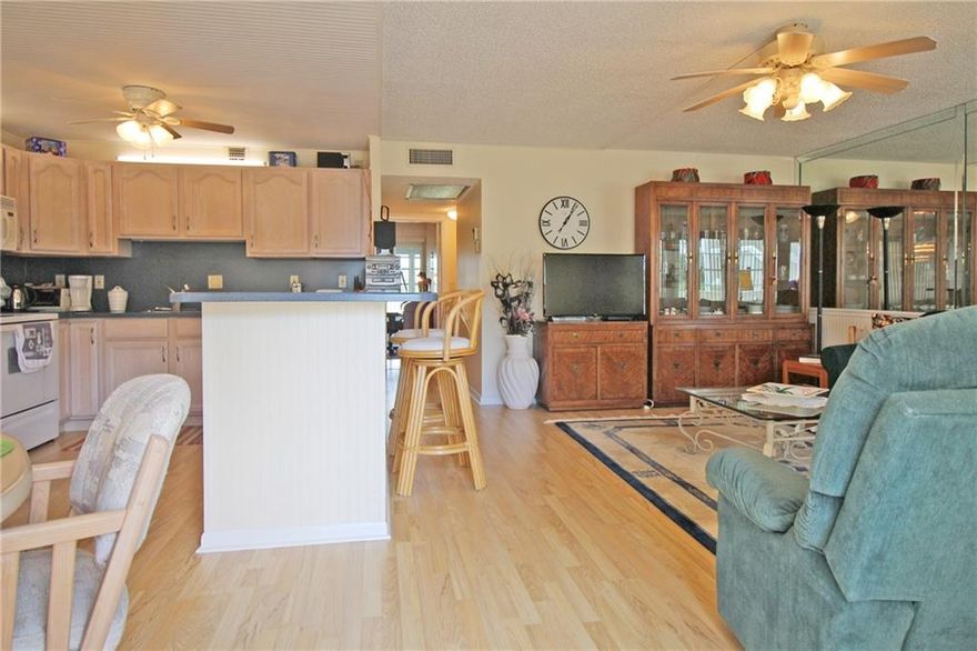 HERE'S THE ONE YOU'VE BEEN WAITING FOR! 2 BEDROOM 2 BATH WITH UPDATED KITCHEN AND BATHS, JUST STEPS FROM THE POOL & TENNIS COURT!!! MOVE RIGHT IN TO THIS BEAUTIFUL UNIT WITH OPEN KITCHEN, UPDATED CABINETRY, LONG BREAKFAST BAR AND EXTENDED CABINETRY INTO THE DINING AREA!! LAMINATE FLOORS THRU-OUT!! FULLY FURNISHED!! THE ENCLOSED PATIO HAS A LOVELY VIEW OF THE GARDEN WITH TILE FLOORS AND AN EXTRA STORAGE CLOSET!! A CEILING FAN IN EVERY ROOM!! 2019 TANKLESS HWH, & 2017 A/C!! NON RENTAL & NON SMOKING BUILDING!! CENTURY VILLAGE EAST IS A GATED COMMUNITY WITH FREE TRANSPORTATION INSIDE AND OUT!! THEIR LAVISH CLUBHOUSE FEATURES CLASSES, CLUBS, MOVIES, BROADWAY SHOWS & STATE OF THE ART GYM!! 10 MINUTES TO THE OCEAN! CLOSE TO FABULOUS SHOPPING, MAJOR HWYS AND GREAT RESTAURANTS! ASSOC. CLAIMS 55+.
