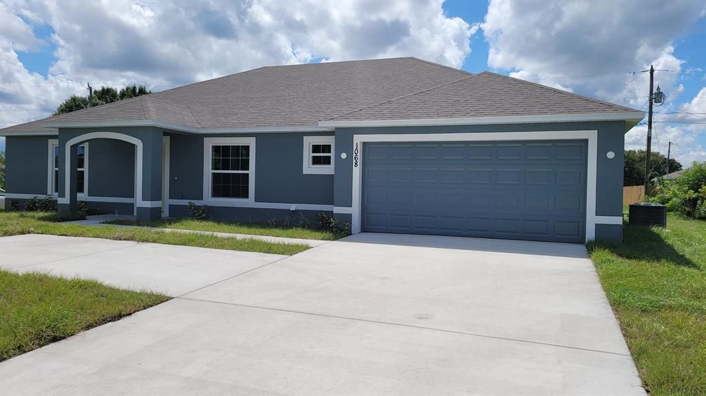 Photo of 1068 SW California Boulevard, Port Saint Lucie, FL 34953 (MLS # R10750872)