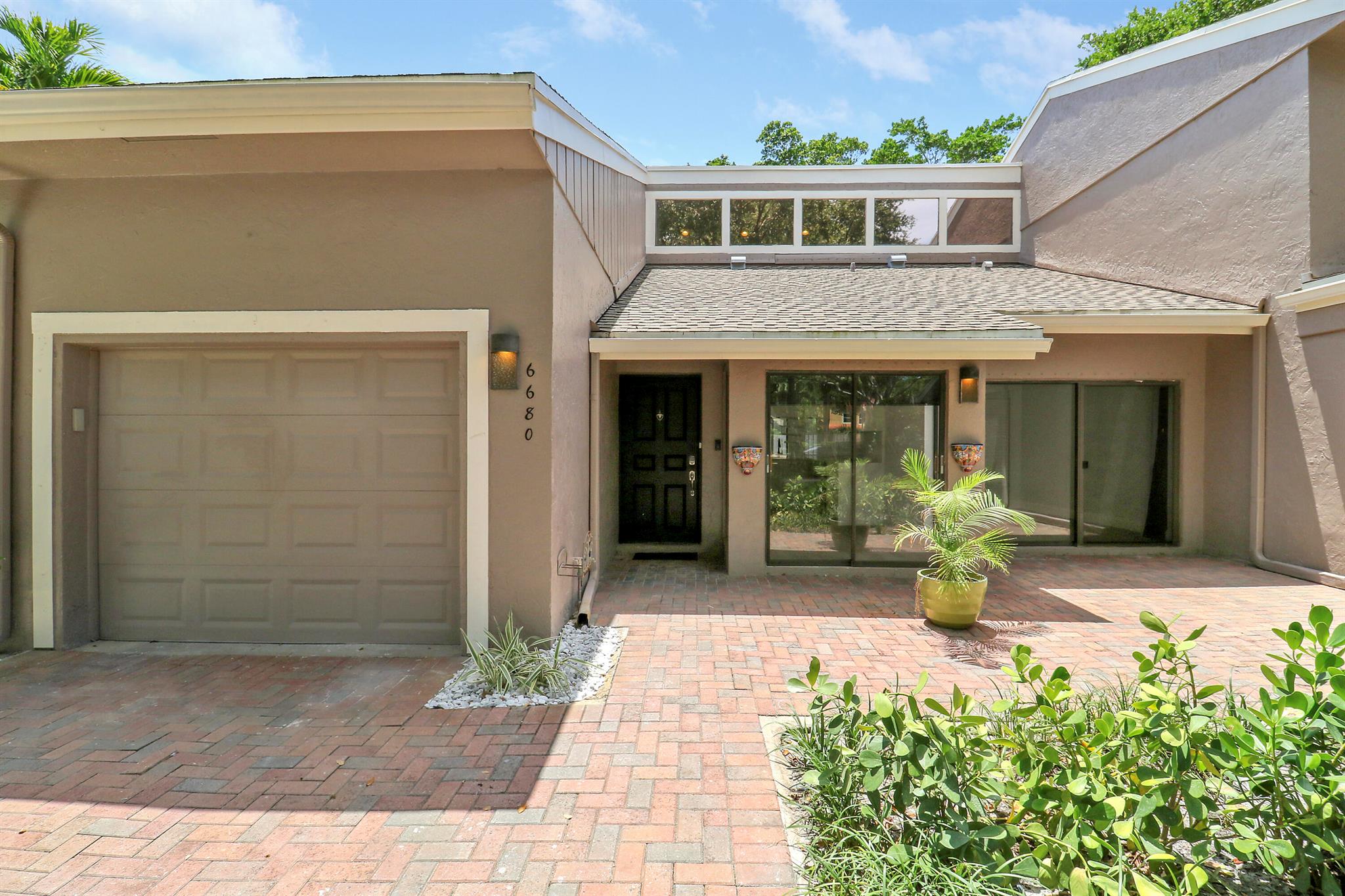 This fully renovated townhouse offers modern style and thoughtful upgrades throughout. The kitchen features granite countertops, soft close cabinetry, stainless steel appliances, and a waterfall style backsplash. New water resistant laminate throughout and tile In the newly renovated bathrooms, creating a warm and seamless flow.Soaring ceilings and large windows fill the home with natural light. A spiral staircase leads to a spacious loft ideal for a home office or flex space. The primary suite includes an updated bathroom with dual sinks, matte black fixtures, a walk in shower, and a skylight. Enjoy a screened patio and a fenced backyard with low maintenance turf and tropical landscaping.