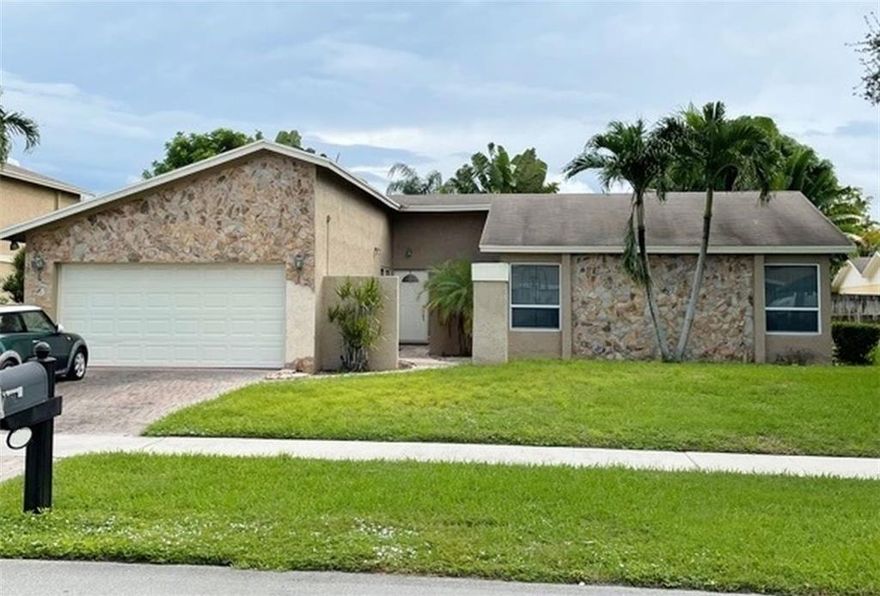 The Villages of Hillsboro. Fantastic homes near great schools! 3/2 home. 2 Car garage, paver driveway and patio. Great yard with plenty of room for pool. Newer A/C. Impact windows and good electric. Beautiful Brazilian cherry wood throughout. Minimal handyman special. Roof is 23 years old & likely needs replacing but doesn't leak. Kitchen has wood cabinetry. Most appliances work but are not warranted.