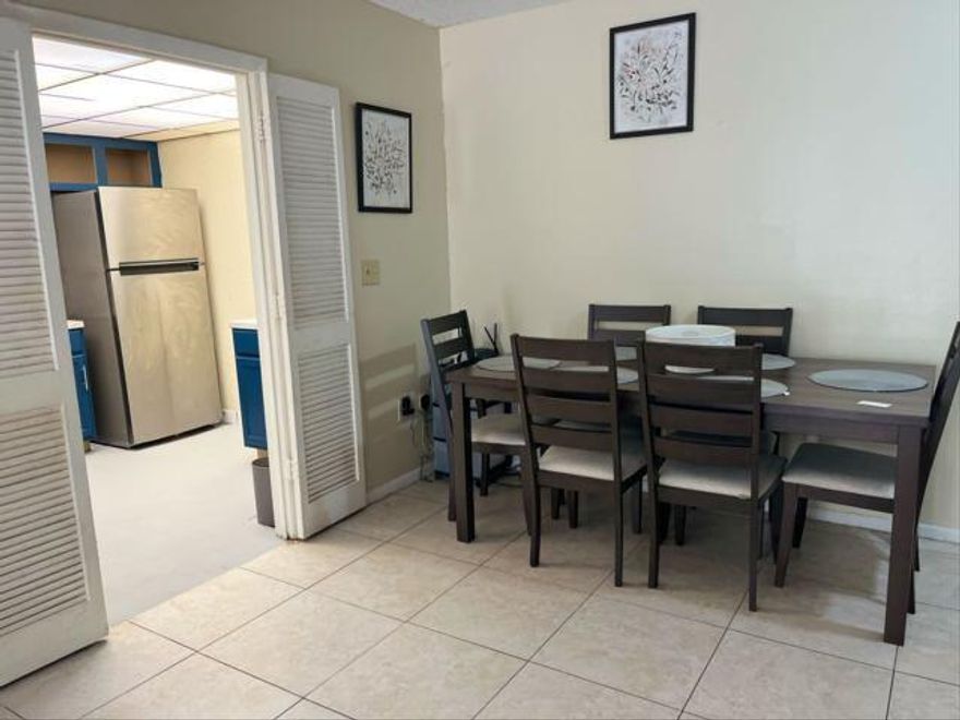 Welcome home to this bright, happy condo that feels huge from the moment you walk in.You're going to love the kitchena"it's got a real personality with deep blue cabinets, modern counters, and stainless steel appliances that make cooking actually enjoyable. The whole place has tile flooring, which looks great and makes cleaning a breeze. The living room gets tons of natural light thanks to the big sliding glass doors, and there's plenty of space to set up a dining area for dinner with friends. The bedroom is spacious (big enough for a king bed!), and outside, you've got perks you'll actually use: tennis and pickleball courts, nice green lawns, and plenty of easy parking.