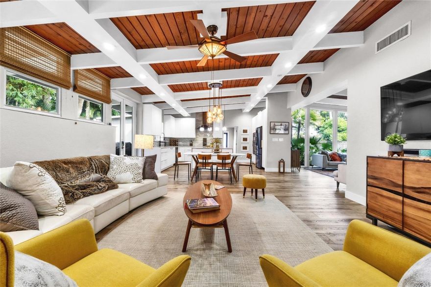 Beautifully renovated residence on an oversized corner lot in the prestigious Coral Gardens neighborhood of East Wilton Manors, just one block west of Federal Highway. This exceptional home offers two primary suites and a bright open floor plan designed for seamless indoor/outdoor living. Vaulted wood-beam ceilings, a wood-burning fireplace, recessed lighting, and expansive windows fill the home with natural light. The designer kitchen features quartz countertops, a waterfall island, custom wood cabinetry, and high-end black stainless-steel appliances. Enjoy a private, fully fenced backyard with pool, lush gardens, automatic gated entry. ideal for entertaining or relaxing. Impact windows and doors. No HOA. Schedule your private showing today. Homes like this are rarely available.